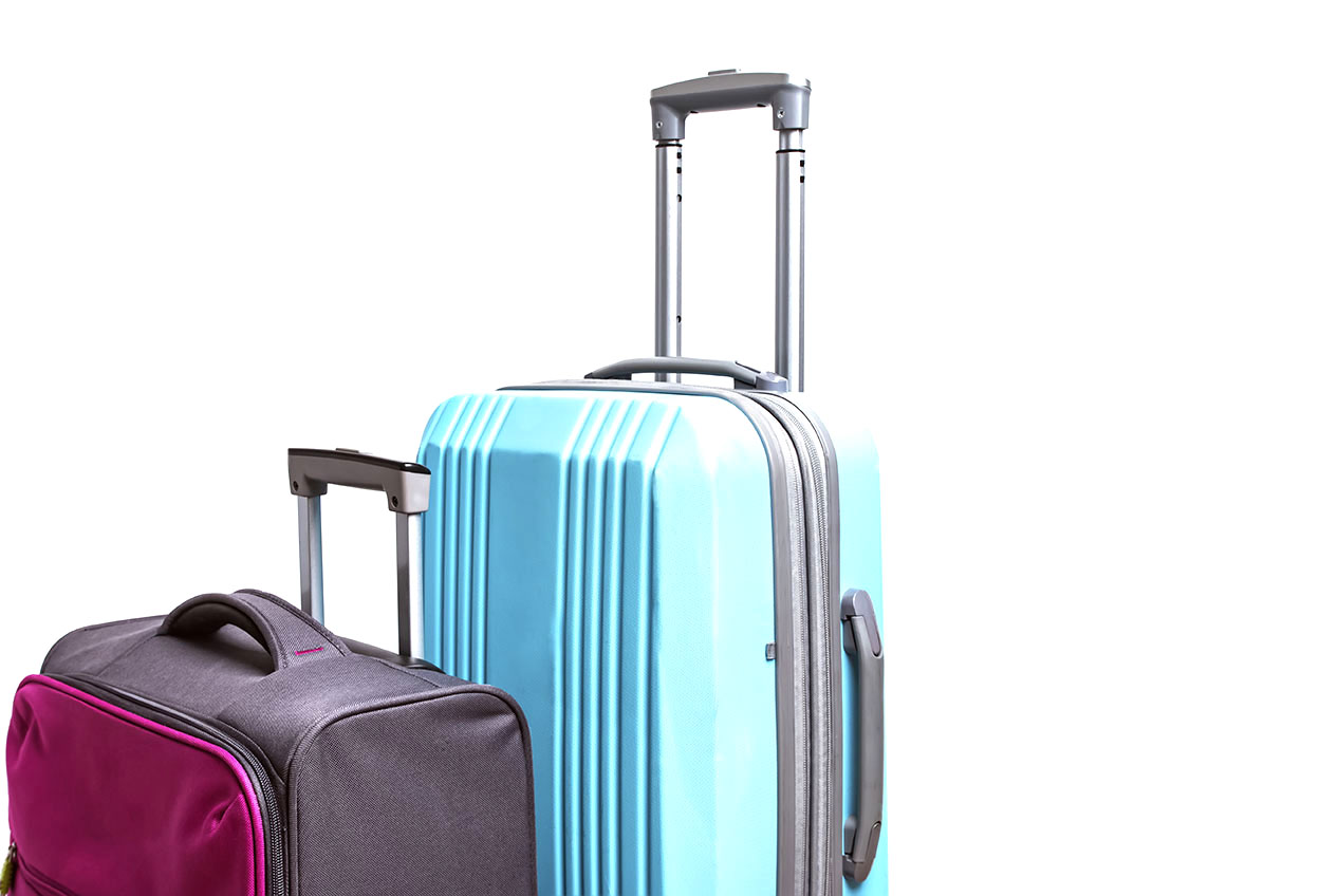 Two suitcases of pink and blue color close-up.